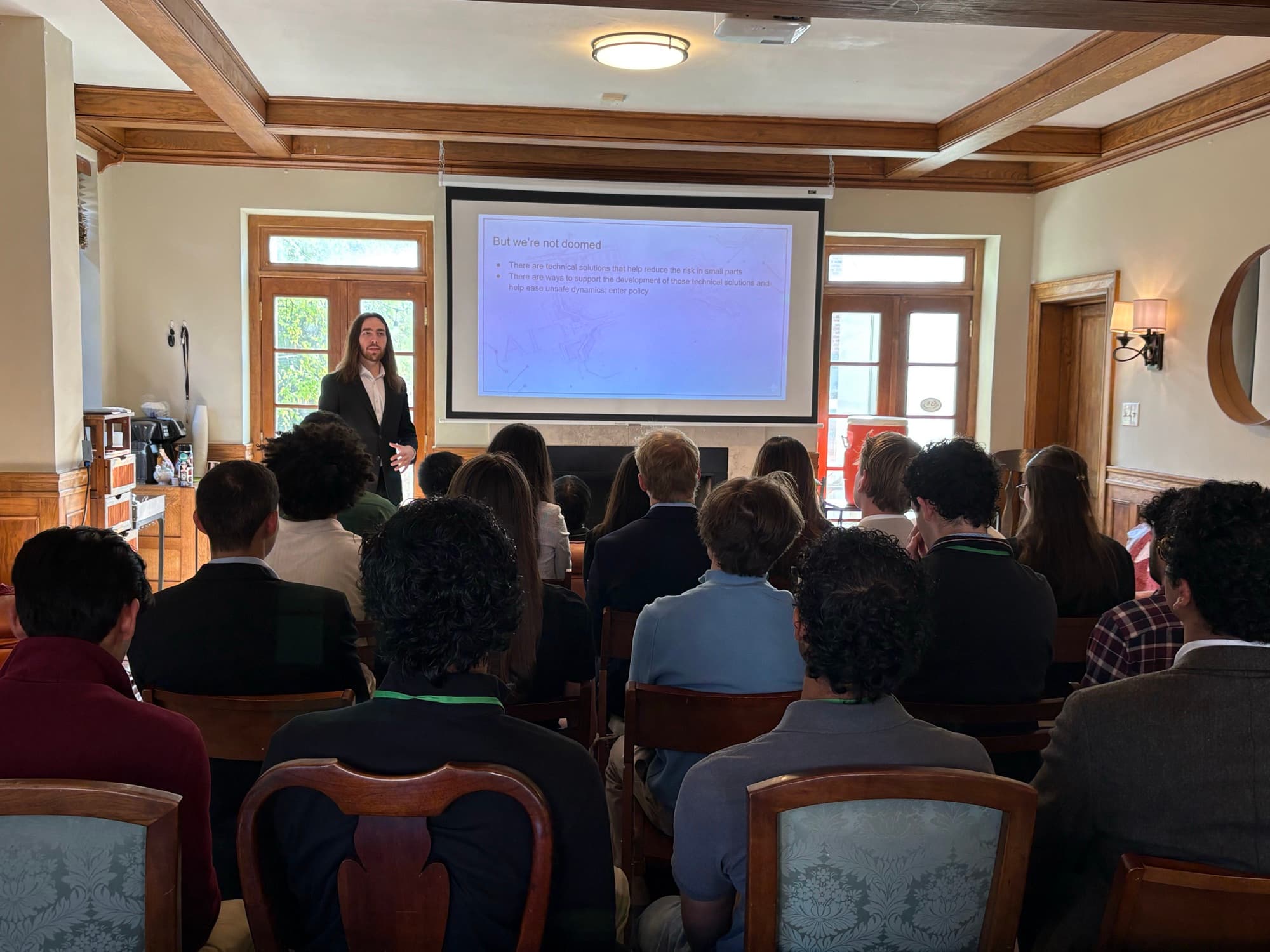 A guest speaker presenting on AI risk and policy at DCMC 1.0